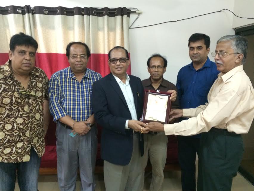 The officials of Bangladesh Sports Journalists Association (BSJA) handing over a crest to State Minister for Youth and Sports Biren Sikder at the office room of BSJA on Thursday.