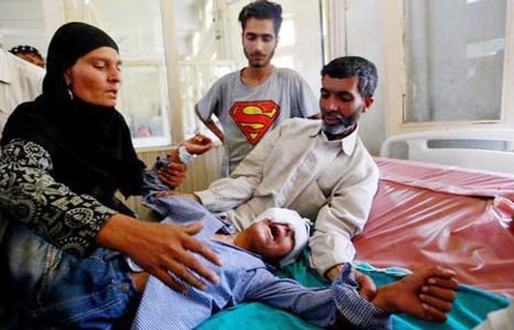 Parents comfort their son whom they say was injured by pellets shot by security forces in Srinagar following weeks of violence in Kashmir on Thursday.