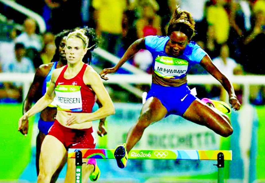 Dalilah Muhammad from the United States jumps a hurdle to win gold medal in the women's 400-meter hurdles final during the athletics competitions of the 2016 Summer Olympics at the Olympic stadium in Rio de Janeiro, Brazil on Thursday.