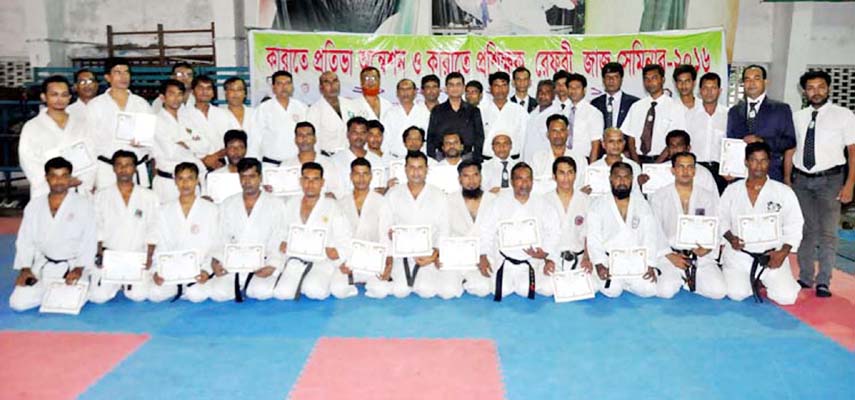 The participants of the karate workshop and the officials of Bangladesh Karate Federation pose for a photo session at the Gymnasium of National Sports Council on Saturday.