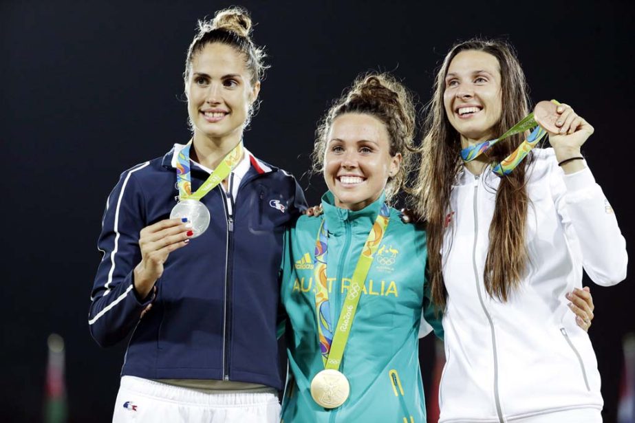 Silver medallist Elodie Clouvel of France, gold medallist Chloe Esposito of Australia and bronze medallist Oktawia Nowacka of Poland, from left to right, pose for a picture at the awards ceremony of the women's modern pentathlon at the Summer Olympics in