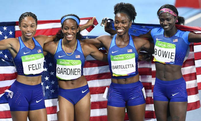 The United States team from left, Allyson Felix, English Gardner, Tianna Bartoletta and Tori Bowie celebrate winning the gold medal in the women's 4x100-meter relay final during the athletics competitions of the 2016 Summer Olympics at the Olympic stadiu
