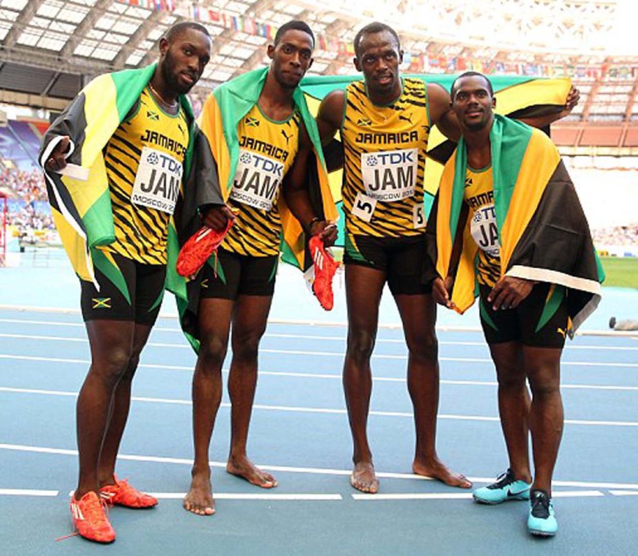 Usain Bolt pictured posing with his Jamaican team-mates on Friday. Jamaican superstar adds 4x100m title to 100m and 200m gold medals and becomes first person to win all three events at three consecutive Olympic Games.