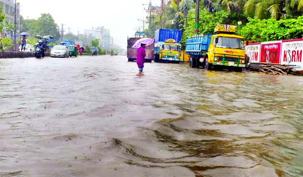 Heavy downpour disrupted life in Chittagong creating obstacles to vehicular movement as vast areas were under waist-deep water. This photo was taken from Nayabazar area near Dhaka-Ctg Highway on Sunday.