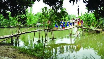 BOGRA: An iron bridge is urgently needed at Singra Upazila on Naribari canal. Local people have made a bamboo bridge voluntarily to meet the emergency . This picture was taken on Sunday.