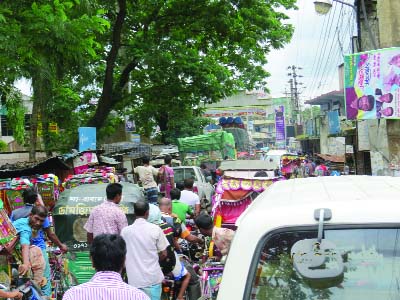 SRIBORDI(Sherpur): Traffic jam is a regular problem at the eastern side of highway of Sribordi Pourashava as shops and rickshaw- vans stands are built there . This picture was taken on Sunday.
