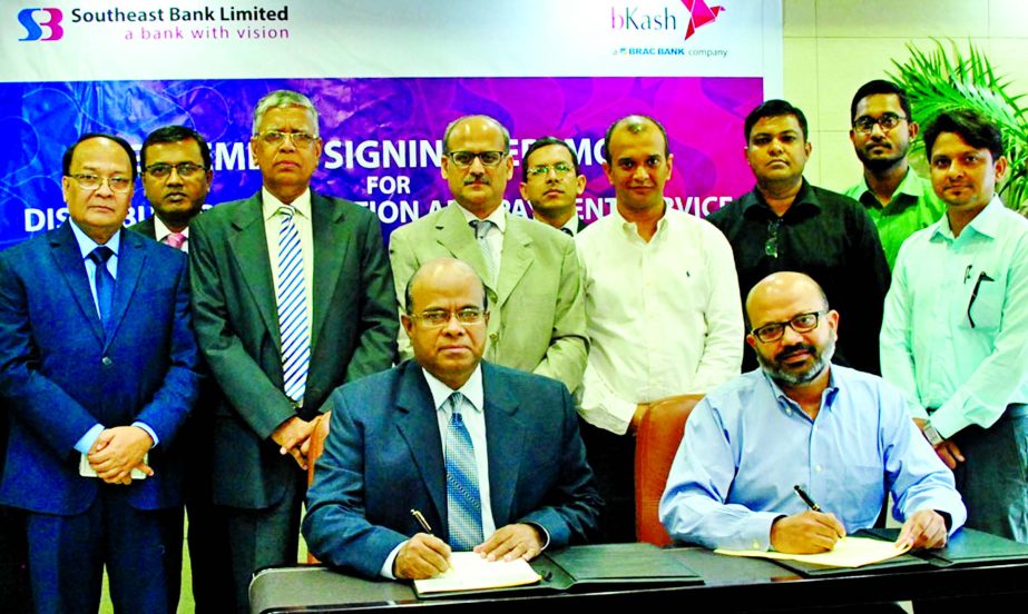 Shahid Hossain, Managing Director of Southeast Bank Ltd and Kamal Quadir, Chief Executive Officer of bKash Ltd, sign an agreement to provide payment and collection service to bKash distributors through the bank's branches network at bank's head office r