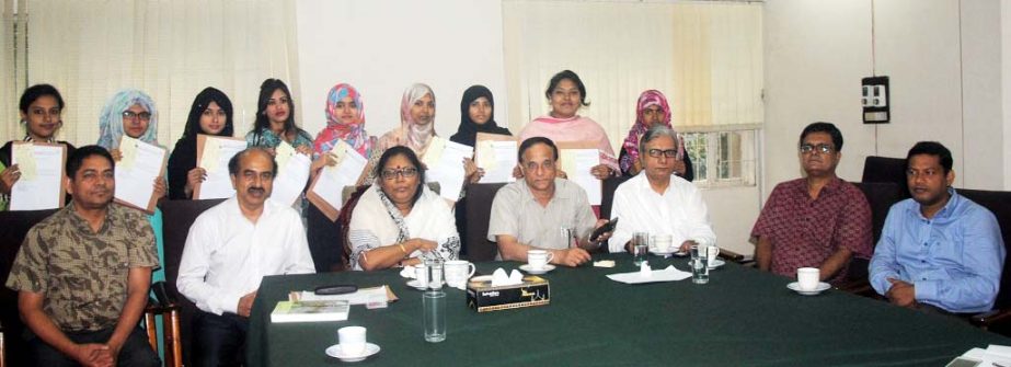 Jahangirnagar University Vice-Chancellor Prof Farzana Islam is seen with the NEF scholarship awardees at a scholarship distribution programme held at the university campus on Monday.