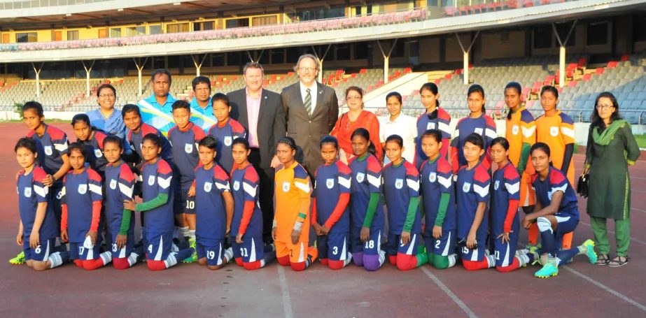 Members of Bangladesh U-16 Womens National Football team with the officials pose for photo at the Bangabandhu National Stadium on Monday.