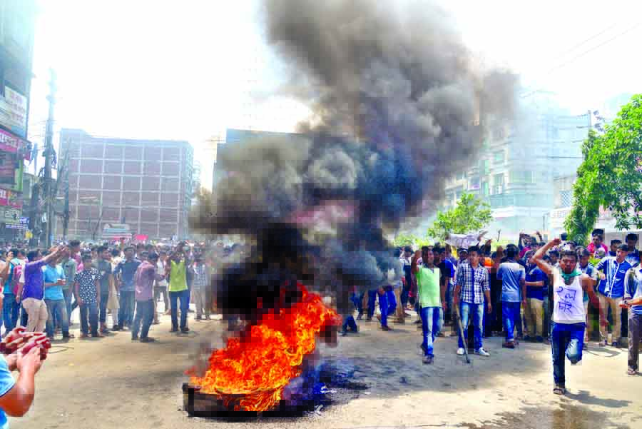 Students of Jagannath University who set fire on the street demanding new residential halls on the empty land of old Dhaka Central Jail, were dispersed as police resorted to teargassing. This photo was taken from Bangshal intersection on Monday.