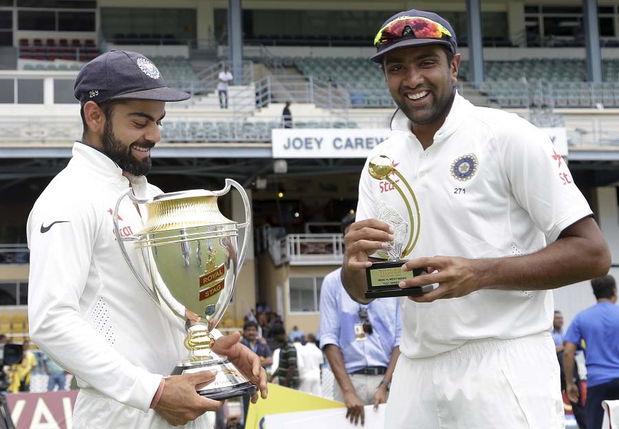 India's captain Virat Kohli (left) holds the trophy for the Test match series Royal Stag Cup 2016 as Ravichandran Ashwin holds the trophy for the man of the series at the Queen's Park Oval in Port-of-Spain, Trinidad. India won the series 2-0 on Monday.
