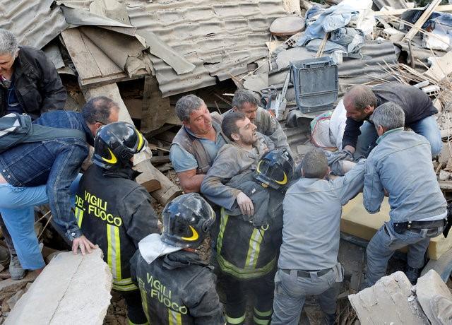 A man is carried away after having been rescued alive from the ruins following an earthquake in Amatrice, central Italy, August 24, 2016. REUTERSRemo Casilli