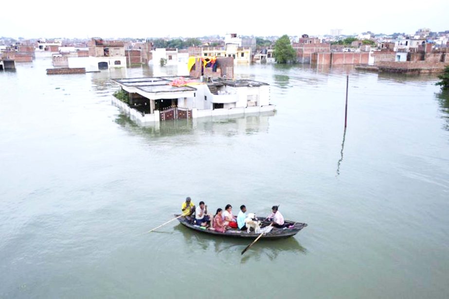 People leave for safer places due to the flooding in the river Ganges in Allahabad, India, on Tuesday.