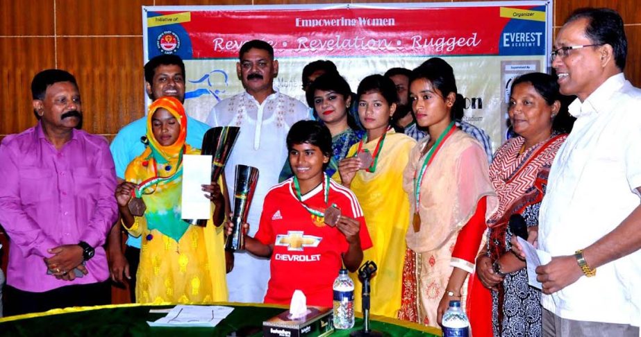 The winners of the First Dhaka Women's Marathon with the officials of Bangladesh Amateur Athletics Federation pose for a photo session at the conference room of Bangabandhu National Stadium on Wednesday.