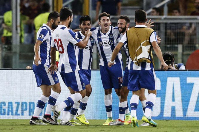 Porto's Miguel Layun (second from right) celebrates with teammates after scoring during a Champions League, play-off, return-leg soccer match between Roma and Porto, at the Rome Olympic stadium on Tuesday.