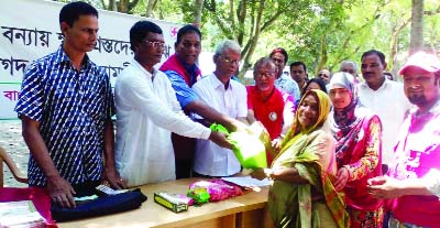 KURIGRAM: Bangladesh Red Crescent Society distributing relief goods and cash money among flood affected families at Chilmari Upazila on Wednesday.