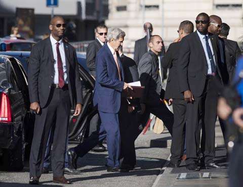 US Secretary of State John Kerry (centre) arrives for a new round of talks on Syria, in Geneva, Switzerland on Friday.