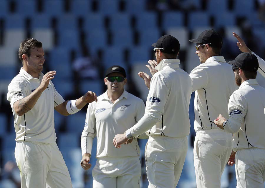 New Zealand's bowler Doug Bracewell (left) celebrates with teammates for dismissing South Africa's batsman Stephen Cook, on the first day of their second cricket Test match at Centurion Park in Pretoria, South Africa on Saturday.