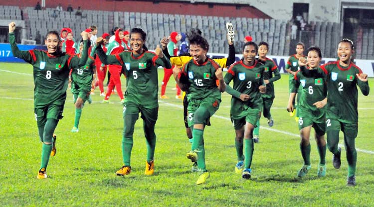 Players of Bangladesh National Women's Under-16 Football team celebrating after beating Iran National Women's Under-16 Football team in their AFC Under-16 Women's Championship Qualifiers at the Bangabandhu National Stadium on Saturday. Bangladesh won t