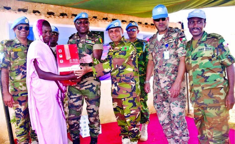 Members of Bangladeshi Peacekeepers Contingent Force Reserve Company-2 in Darfur, Sudan distributing sewing machines among the destitute in a local camp recently. ISPR photo