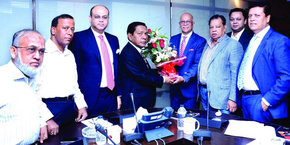 MA Sabur, Chairman of United Commercial Bank Limited, presenting flower bouquet to Akhter Matin Choudhury, for being elected new Audit Committee Chairman of the bank at the head office on Sunday. Anisuzzaman Chowdhury, Vice-Chairman, Showkat Aziz Russell