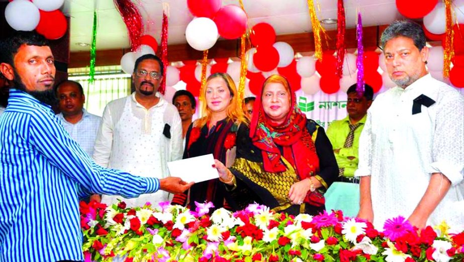 Parveen Haque Sikder, Chairperson of Executive Committee of the Board of Directors of National Bank Limited, distributing cheque among the poor farmers of Gopalgonj District under "Daridro Mukti" package recently. Lisa Fatema Haque Sikder, Director of S