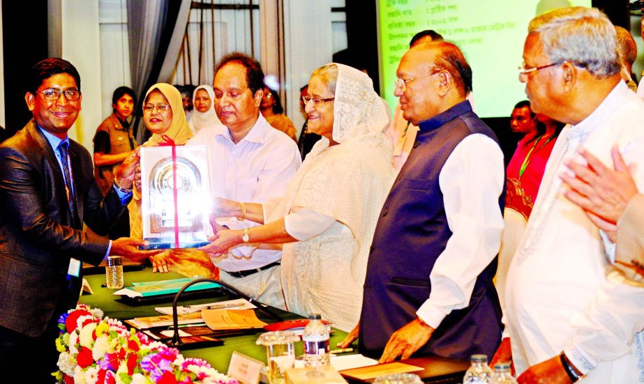 RN Paul, Director of RFL receiving National Export Trophy for FY-2012-13 from Prime Minister Sheikh Hasina at Osmani Memorial Hall in the city on Sunday.