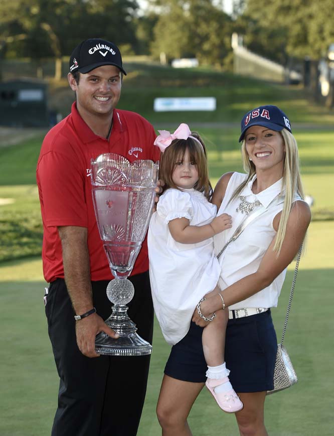 Patrick Reed holds the Barclays trophy together with his wife Justine and daughter, Windsor-Wells Reed, 2, after Reed won the Barclays golf tournament in Farmingdale, N.Y. on Sunday.