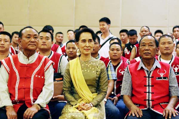 Myanmar's Foreign Minister Aung San Suu Kyi, (centre) sits with members of the United Wa State Army (UWSA) as they pose for photographs following a meeting of armed ethnic groups in Naypyitaw, Myanmar.