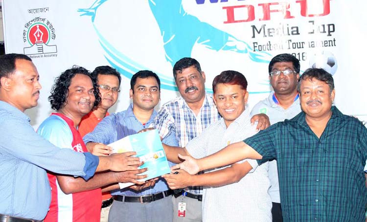 Former president of Dhaka Reporters Unity (DRU) Shahed Chowdhury (3rd from right) handing over the Man of the Match award of the Walton-DRU Media Cup Football Tournament at the Shaheed (Captain) M Mansur Ali National Handball Stadium on Tuesday.