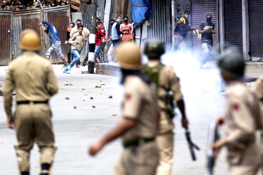 Kashmiri protesters face Indian policemen in Srinagar, Indian controlled Kashmir on Wednesday.