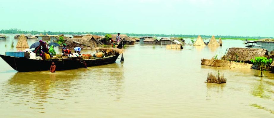 RAJSHAHI: Flood affected people of Padma River bank moving one place to another with their essentials for safer place. This snap was taken from Charkhidirpur area on Tuesday.