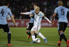 Argentina's Lionel Messi (center) strikes the ball to score against Uruguay during a 2018 World Cup qualifying soccer match in Mendoza, Argentina on Thursday.