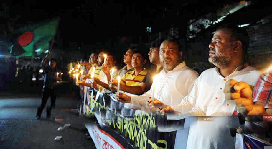 The members of Muktijudda Sangsad Santan Command celebrating the execution of the war criminal and Al Badr Chief of Chittagong Mir Quasem Ali by lightning candle in front of former Dalim Hotel in city after execution of hanging on Saturday night.