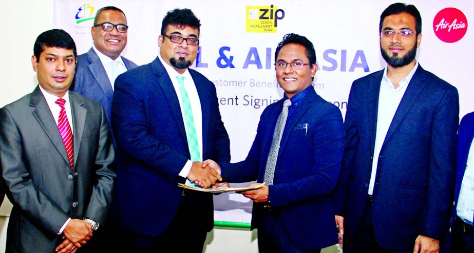 M. Nazeem A. Choudhury, Head of Consumer Banking of Eastern Bank Limited (EBL) and Morshedul Alam Chaklader, Director and CEO of Air Asia's GSA - Total Air Services exchange documents after signing a Zero Percent Installment Plan (ZIP) agreement in the