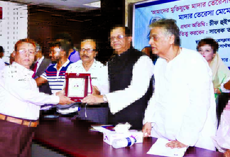 Chief Whip of the Jatiya Sangsad ASM Firoj handing over Mother Teresa Memorial Award to MI Majumder (Miraj) for his contribution in social services at a ceremony organised by Mother Teresa Research Center at the Jatiya Press Club on Sunday marking Mother