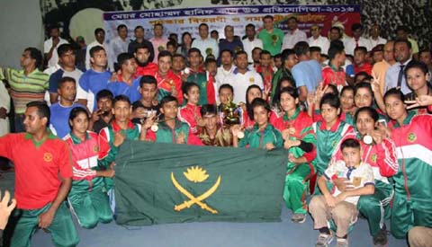 State Minister for Youth and Sports Dr Biren Sikder poses for photograph with Bangladesh Army team, who clinched the title of Mayor Mohammad Hanif National Wushu Competition at the Gymnasium of National Sports Council on Saturday.