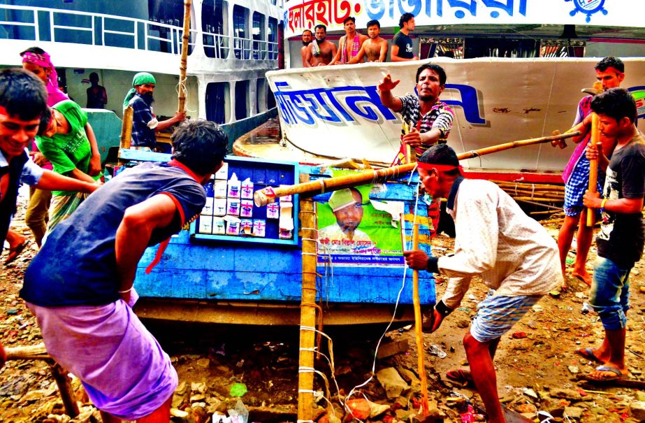 Unauthorised establishments being evicted by BIWTA from the bank of Buriganga in city's Sadarghat area on Sunday.