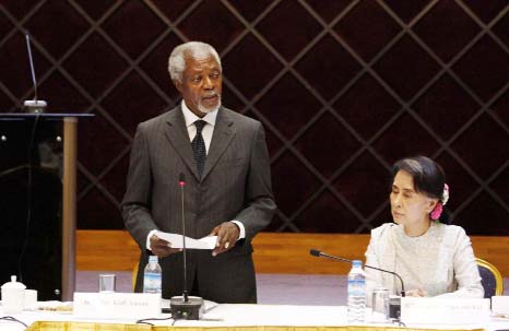 Former U.N. Secretary-General Kofi Annan speaks as Myanmar Foreign Minister Aung San Suu Kyi, left, listens during a meeting with members of the National Reconciliation and Peace Center (NRPC) on Monday.