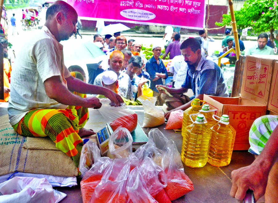 Buyers crowd to take essential commodities in TCB's fair price. The snap was taken from in front of the Jatiya Press Club on Monday.