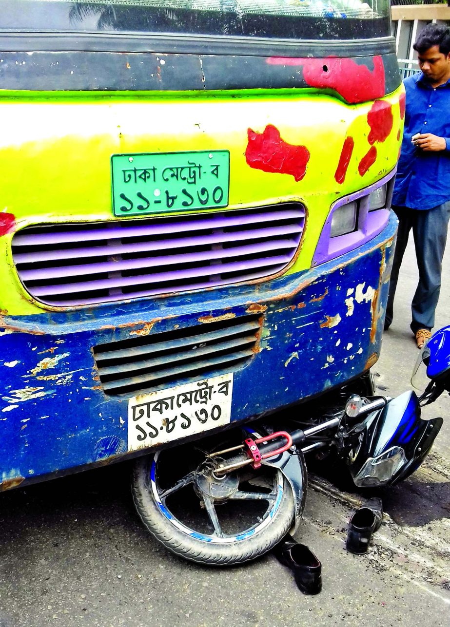 The wreckage of a motorbike under wheels of a passenger bus in front of the city's National Eidgah on Tuesday. The collision left the motorcyclist critically injured and his shoes left abandoned.