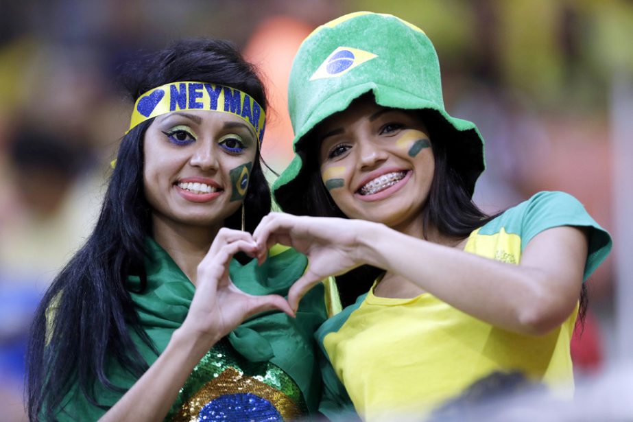 Fans of Brazil join hands forming the figure of a heart prior to a 2018 World Cup qualifying soccer match between Brazil and Colombia in Manaus, Brazil on Tuesday.