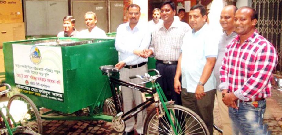 CCC Mayor A J M Nasir Uddin receiving garbage vans from Md Faridul Alam, owner of Popular Bricks at Nagarbhaban on Wednesday.