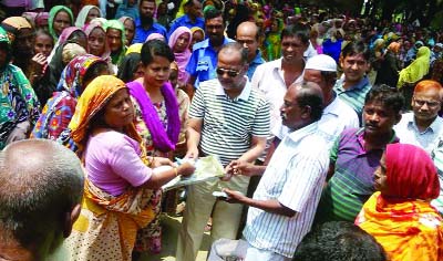 MYMENSINGH: Afzal Uddin Sarkar, Chairman, Akua Union Parishad distributing VGF cards, saris and lungis and cash taka among the poor people of the upazila recently.