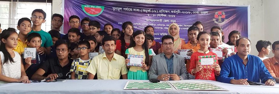 The winners of the grass-root level under-16 chess players training programme with the officials of Bangladesh Chess Federation pose for photograph at Bangladesh Chess Federation hall-room on Saturday.
