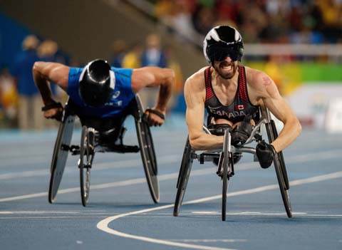 In this photo released by IOC, Canada's Brent Lakatos crosses the finish line to win the gold in the men's final 100-meter T53 athletics event at Olympic Stadium during the Paralympic Games in Rio de Janeiro, Brazil on Friday.