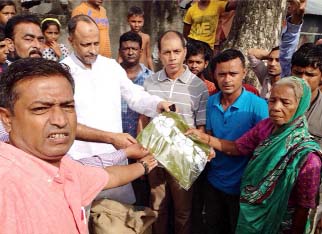 MA Latif MP distributing clothes and food stuff among the fire victims yesterday.