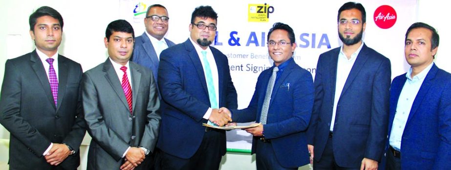 M. Nazeem A. Choudhury, Head of Consumer Banking of Eastern Bank Limited (EBL) and Morshedul Alam Chaklader, Director and CEO of Air Asia's GSA - Total Air Services exchange documents after signing a Zero Percent Installment Plan (ZIP) agreement in the