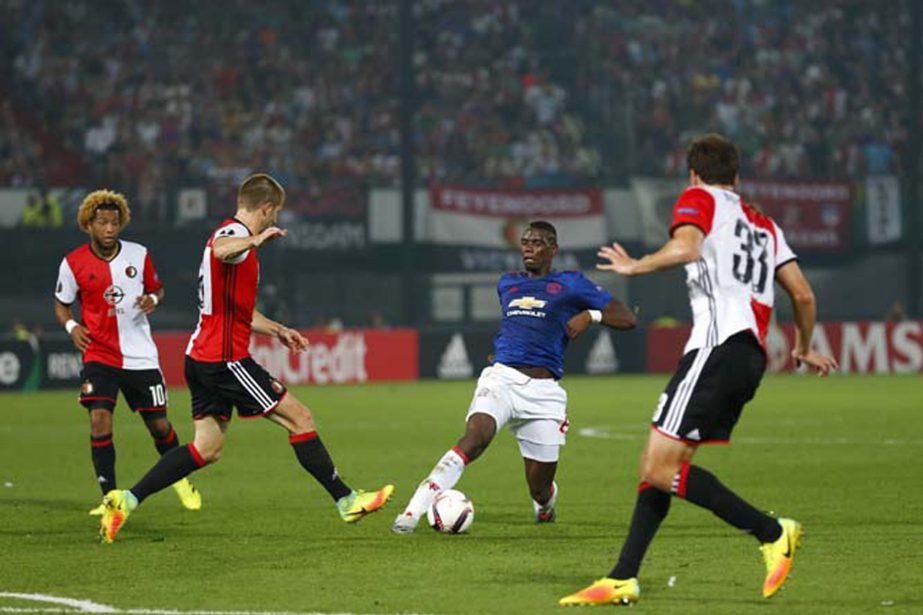 United's Paul Pogba (center) tries to get through the Feyenoord defense during the Group A Europa League match between Feyenoord and Manchester United at the De Kuip stadium in Rotterdam, Netherlands onThursday.