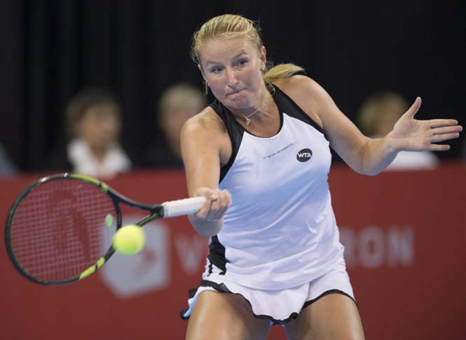 Alla Kudryavtseva of Russia returns to Eugenie Bouchard of Canada at the Coupe Banque Nationale tennis tournament in Quebec City on Thursday. Kudryavtseva won 6-2, 6-3.